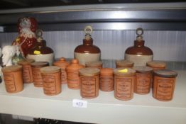 A collection of Henry Watson spice jars and three