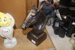 A bronzed model of a horses head (132)