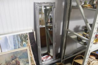 An ornate framed and bevel edged wall mirror