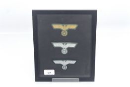 Three German cloth eagle badges, framed and glazed