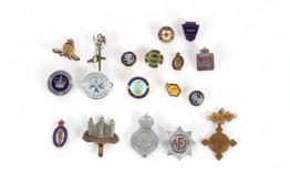 A collection of various badges and insignia includ