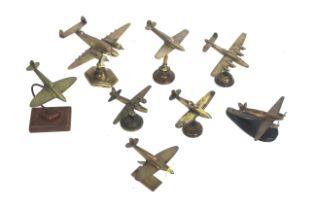 Eight model brass WWII planes on various stands
