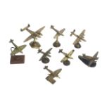 Eight model brass WWII planes on various stands