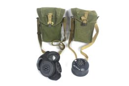 Two WWII era canvas gas mask cases, one with conte