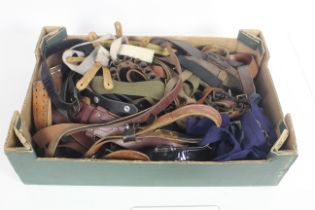 A box full of various belts, Sam Brownes and sword
