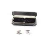 A pair of white metal cuff-links with R.A.F. insig