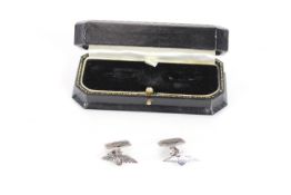 A pair of white metal cuff-links with R.A.F. insig