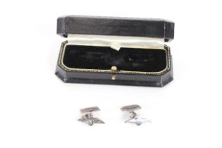 A pair of white metal cuff-links with R.A.F. insig