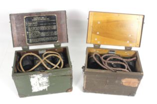 Two WWII era field telephones within their transit