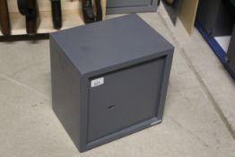 A near new small safe (one key) approx. 12" high x