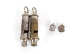 Two A.R.P. lapel badges with two A.R.P. whistles