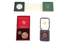 Three various cased medallions including ERVII exa
