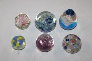 Six various glass paperweights