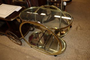 A retro brass and glass drinks trolley