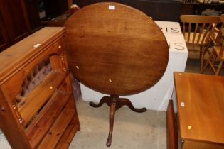 An antique oak tripod occasional table, the circul