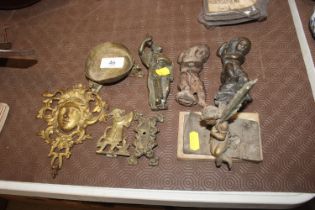 An antique bronze figure of a cherub, a cast iron similar, a bronze figure of an Oriental Deity; a