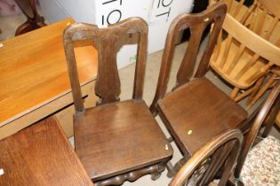 A pair of antique oak Queen Anne style dining chairs