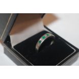 A 9ct white gold emerald and diamond set ring, rin