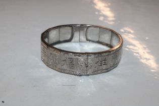 A white metal snap bangle, tested containing silve