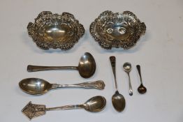 A collection of silver and white metal spoons; two