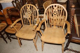 A pair of stick and wheel back elbow chairs and a