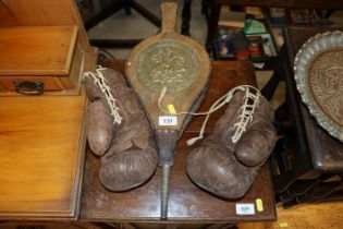 A pair of vintage boxing gloves and a set of brass