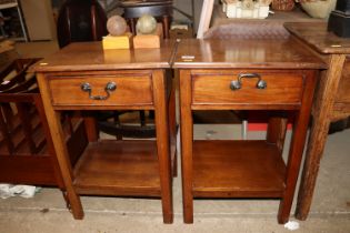 A pair of mahogany two tier bedside tables fitted