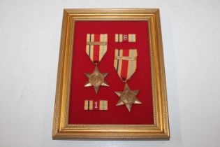 Two WWII Africa Stars with bars, mounted on displa