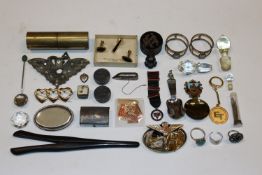 A pair of glove stretchers, various badges, cuff-l