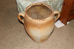 A glazed pottery twin handled urn