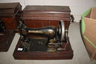 A Singer hand sewing machine in fitted case