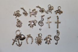 A collection of white metal and silver charms, app