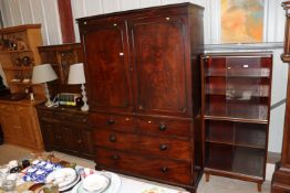 A Georgian mahogany linen press fitted sliding tra