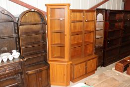 A teak effect corner cupboard