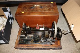 A Frister & Rossman sewing machine in inlaid case