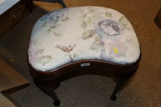 A kidney shaped dressing stool