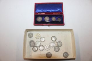 A box of silver and other threepences; and a set o