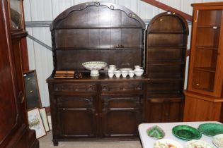 An Ercol style oak dresser with arched plate rack
