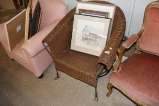 A conservatory wicker and iron tub shaped chair