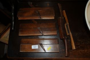 Three wooden moulding planes and two spoke shaves