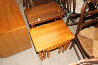 A nest of two oak occasional tables and a nest of