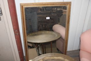 A gilt framed wall mirror