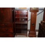 A Minty bookcase enclosed by glazed sliding doors