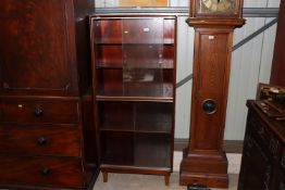 A Minty bookcase enclosed by glazed sliding doors