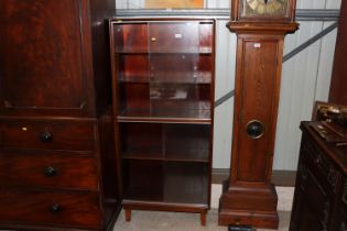 A Minty bookcase enclosed by glazed sliding doors