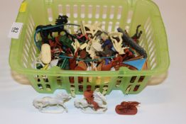 A basket of plastic cowboy and Indian figures