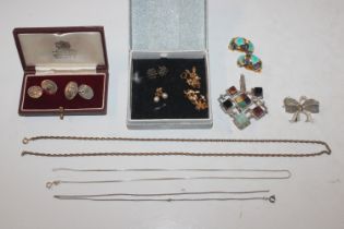 A white metal pendant marked 900 set with various