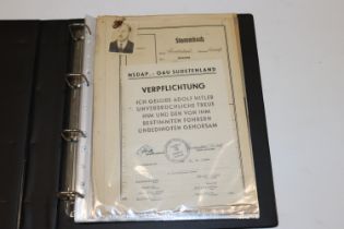 A folder of German WWI and WWII ephemera all relat