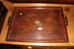 An Edwardian oak tea tray with small silver cartouche