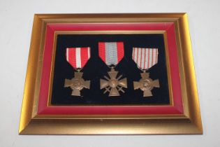 Three French Bravery medals mounted on display boa